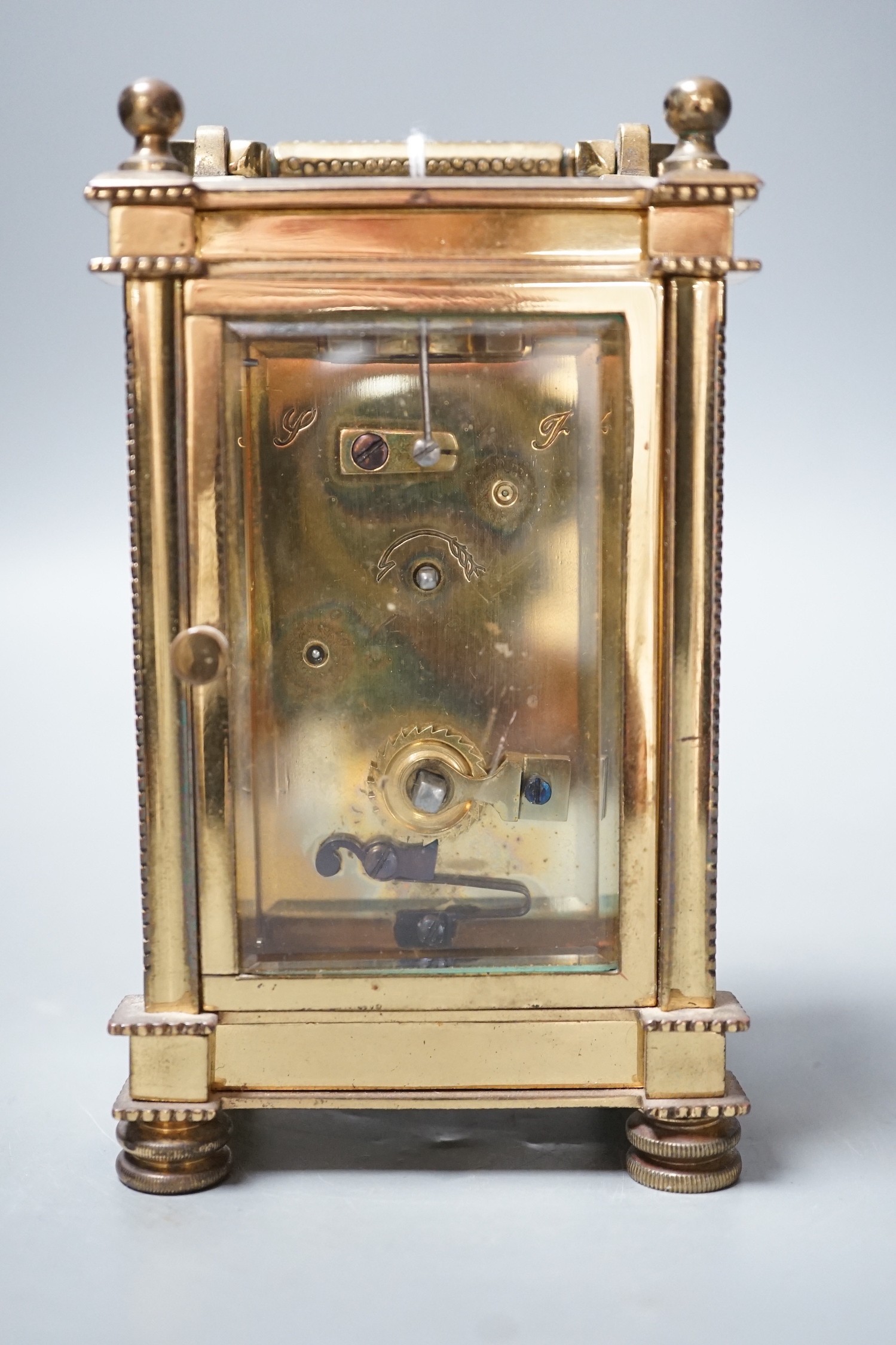 An Edwardian brass carriage timepiece, with pearl applied dial, 12cms high